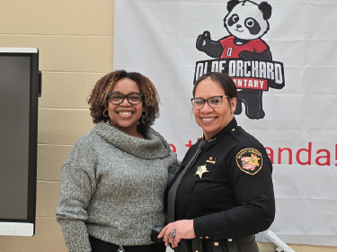 teacher posing with sherriff